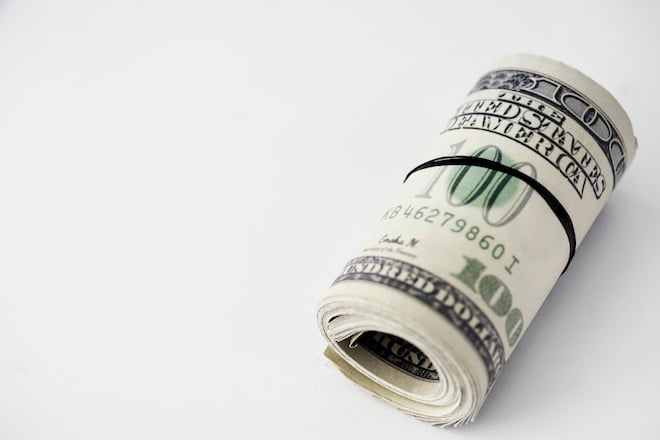 Closeup of money bundle isolated on white background