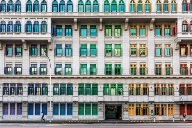 building with windows painted in shades of the rainbow