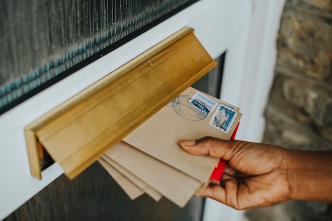 mail being delivered in mail slot